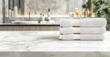 Neatly folded white towels on a marble countertop in a minimalist, luxurious bathroom with soft lighting and stylish decor photo