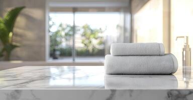 Blurred bathroom interior with a white marble table and a stack of towels on a blurred background, suitable for a product display montage photo