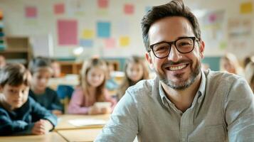 Portrait of smiling male teacher in a class at elementary school looking at camera photo