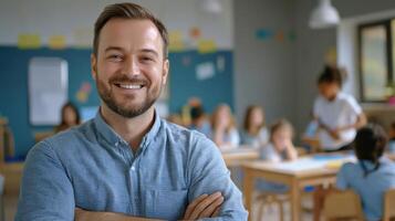 Portrait of smiling male teacher in a class at elementary school looking at camera photo