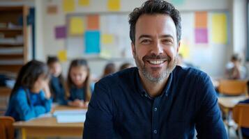 Portrait of smiling male teacher in a class at elementary school looking at camera photo