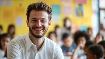 Portrait of smiling male teacher in a class at elementary school looking at camera photo