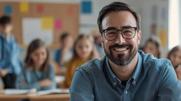 Portrait of smiling male teacher in a class at elementary school looking at camera photo