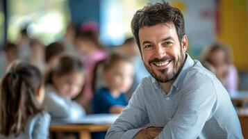 Portrait of smiling male teacher in a class at elementary school looking at camera photo