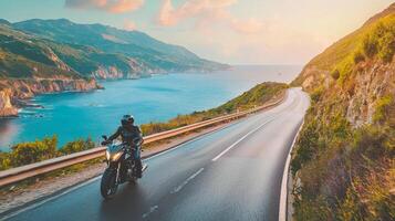 Motorcyclist cruising along coastal highway. A biker enjoying a solitary ride on a coastal road photo
