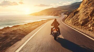 Motorcyclist cruising along coastal highway. A biker enjoying a solitary ride on a coastal road photo