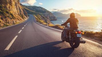 Motorcyclist cruising along coastal highway. A biker enjoying a solitary ride on a coastal road photo