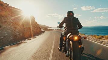 Motorcyclist cruising along coastal highway. A biker enjoying a solitary ride on a coastal road photo
