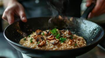 The chef prepares Risotto with mushrooms. Risotto with mushrooms is served in an elegant plate photo