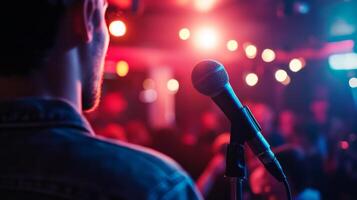 Comedian performing stand-up show on stage routine in comedy club photo