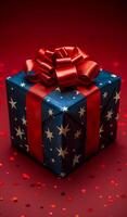 A blue and red box with a red bow on top. The box is decorated with stars and is sitting on a red background photo