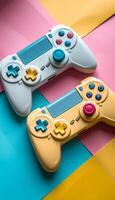 Two white and yellow game controllers are placed on a colorful background. The controllers are positioned in a way that they appear to be ready for action, with their buttons photo