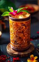 A drink with a flower on top of it is sitting on a wooden coaster. The coaster is on a table with other items photo