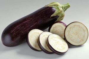 Freshly sliced eggplant with whole vegetable, showcasing its vibrant purple skin and creamy interior on a light background photo