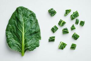Fresh green leafy vegetable with chopped pieces arranged artistically on a light background, perfect for healthy recipes and meal prep ideas photo