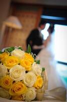 A bouquet of yellow and white roses photo