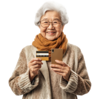 Smiling senior woman holding holding a credit card and a mobile phone, standing front view isolate on transparent background png