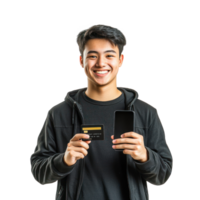 Smiling young man left holding holding a credit card and right hand holding mobile phone, standing front view isolate on transparent background png