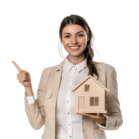 Smiling young businesswoman holding house for mortgage with hand pointing at empty space front view isolate on transparent background png
