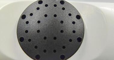 A close up of a white and black object with holes photo
