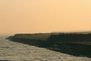 Beautiful Sunrise Over Green Fields and River Break on Monpura Dwip photo