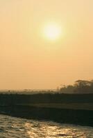 Beautiful Sunrise Over Green Fields on Monpura Dwip photo
