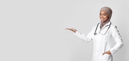 Effective Flu Remedy. Young Black Female Doctor Holding Invisible Item On Her Palm, Showing New Vitamin Complex, Demonstrating Pack With Medicine photo