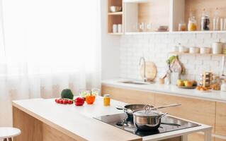 A kitchen featuring a stove top oven placed next to a counter. The stove is equipped with burners and knobs, while the counter offers space for food preparation photo
