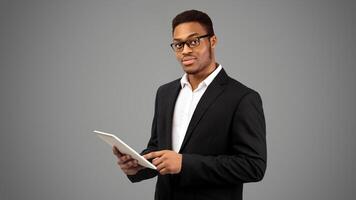 African American Man Holding Tablet, Looking Serious. Panorama, empty space photo