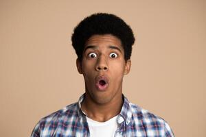 Omg. Shocked guy looking at camera over white studio background photo