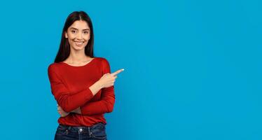 A woman wearing a red shirt is pointing at an unidentified object or direction. Her gesture is assertive, suggesting she is drawing attention to something specific, empty space photo
