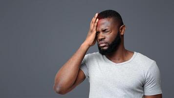 Brain diseases problem cause chronic severe headache. Young black man tired and stressed, having mental problem trouble, medical concept photo