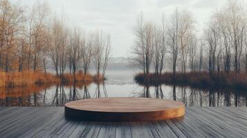 A round wooden platform sits peacefully on a misty lake, surrounded by leafless trees reflecting on the still water. The soft morning light enhances the tranquil atmosphere of this nature setting. photo