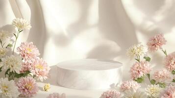 Soft pastel flowers in shades of pink and white encircle a smooth marble pedestal, illuminated by gentle light against a cream backdrop. The composition creates a serene and elegant atmosphere. photo