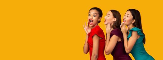 Gossip Concept. Three Beautiful Girls Sharing Secrets And Rumors Standing Over Yellow Studio Background. Panorama photo