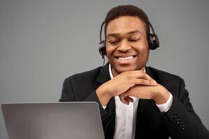 Friendly Operator. African american sales manager consulting client looking at captop camera, free space photo