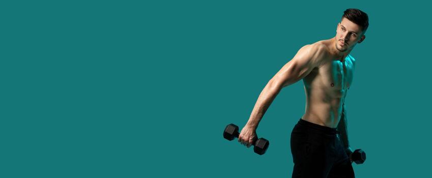 A man is lifting dumbbells while standing on a green background. He is focused and determined, with his muscles engaged. The mans form is precise as he performs the exercise, empty space photo