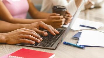 Internet surfing. African american student using laptop, typing text in library, close up photo