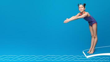 Cute girl about to dive off diving board into swimming pool, blue studio background photo