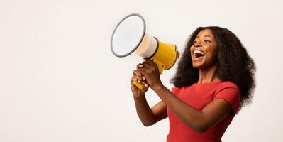 Great Promo. Excited Black Lady Using Megaphone For Making Announcement, Cheerful African American Woman Holding Loudspeaker, Sharing News While Standing On White Background, Panorama, Copy space photo