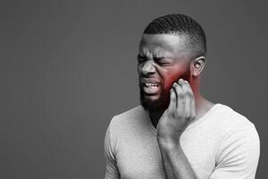 Young black man having wisdom teeth problem, suffering from acute toothache photo