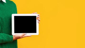 Useful Application Or Website. Unrecognizable afro teenager holding tablet with blank black screen, mock up, empty space photo
