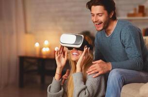 Virtual Reality. Excited Couple Using VR Glasses Playing Videogame Having Fun Sitting On Floor At Home photo