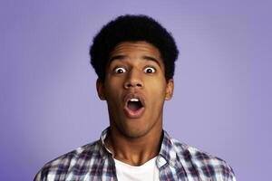 Surprised and Shocked Teenage Guy Opened Mouth in Amazement, Pink Studio Background photo