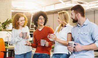 Coffee break at modern company. Cheerful coworkers enjoying communication during free time, panorama photo