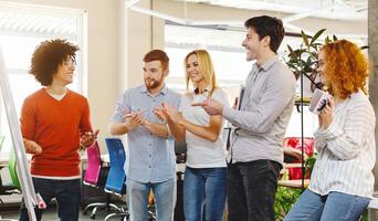 Business team appreciating colleague for explaining presentation, applauding in co-working space photo