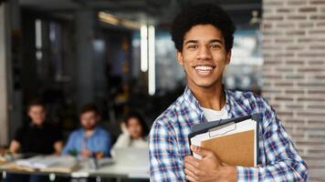 Learning and education concept. Happy student with books looking at camera in library photo