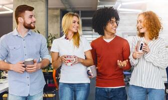 A gathering of individuals standing closely aligned in a row, facing forward, engaged in conversation or awaiting further instructions while drinking coffee photo
