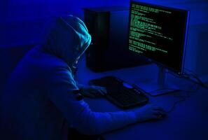 Cybercrime and Hacking Concept. Unrecognizable Hacker Using Computer Virus Program For Cyber Attack photo
