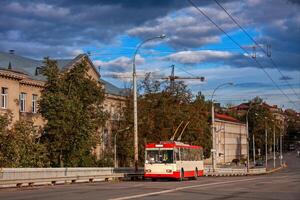 Old white-red trolleybus on the background of the building. Vilnius, Lithuania. photo